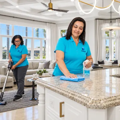 Iris and Carla from iClean cleaning a kitchen island and vacuuming a living room together